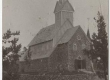 Ruhnu uus kirik (pühitsetud 1912), selle tagant paistmas vana puukiriku tornitipp - EAA