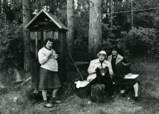 Betti Alver (keskel istumas) oma Pühaste kodu õues vestlemas praeguse perenaise (vas. 1.), Velly Verevi ja Linda Niguliga 1982. a